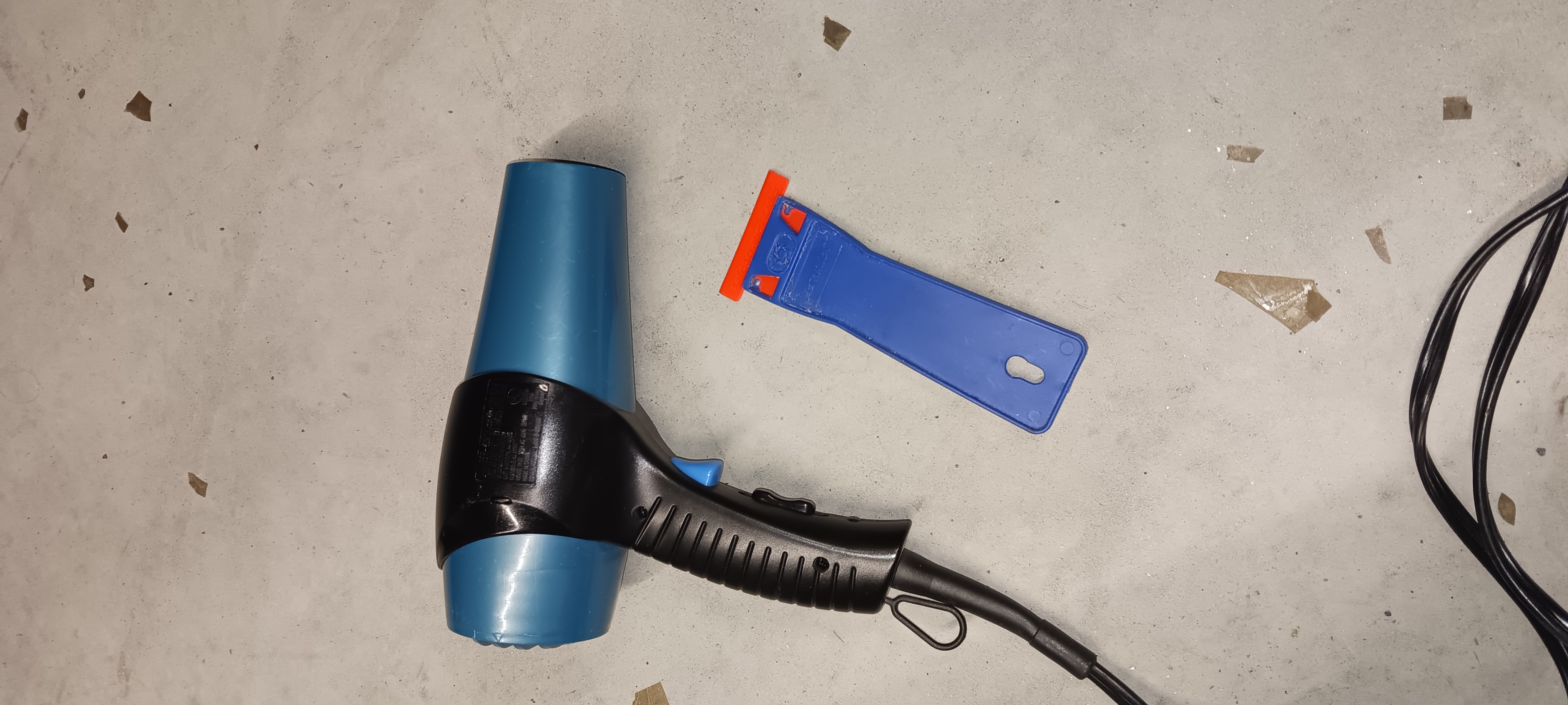 Hair dryer and plastic razor scraper